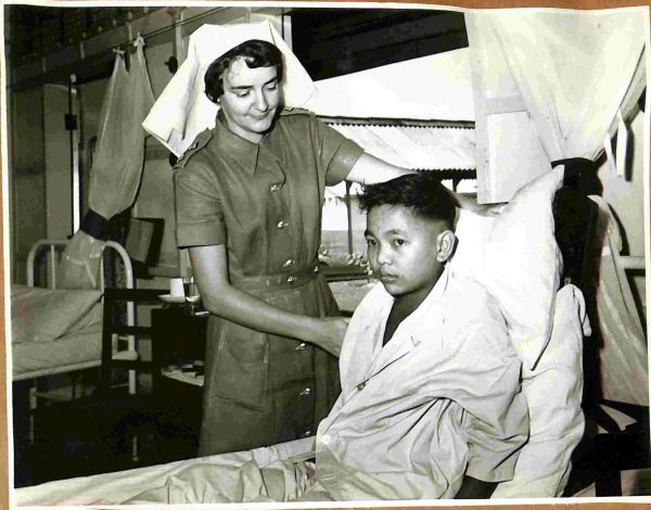 1957 Lt Betty Abbott of Tasmania comforts a ghurka soldier at BMH Kamunting, Malaya