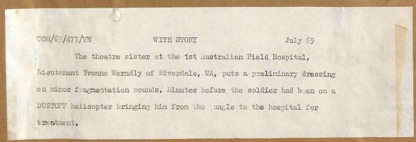 1969 The theatre sister at the 1st Australian Field Hospital, Lieutenant Yvonne Werndly of Riverdale, WA, puts a preliminary dressing on minor fragmentation wounds. Minutes before the soldier had been on a DUSTOFF helicopter bringing him from the jungle to the hospital for treatment.