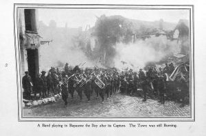 Page 65: A band playing in Bapaume the day after its capture. The town was still burning.