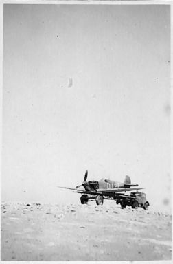 RAF breakdown truck returning with a plane that has made a forced landing.