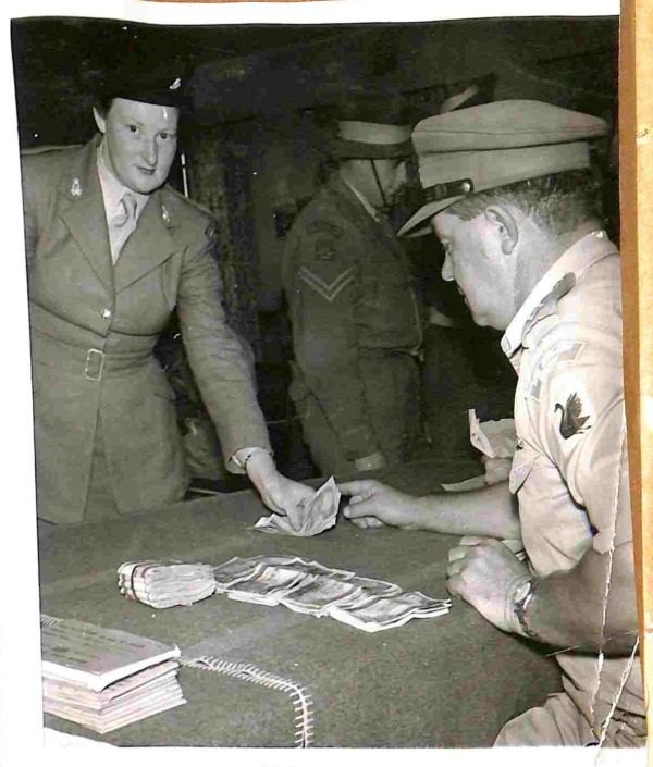 1953 Pte Betty Light RAANC being paid.